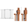 Gray extra tall metal pet gate with arched top mounted on a banister