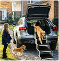 Folding aluminum dog steps leaning against the rear of an SUV