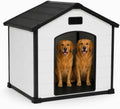 Large resin igloo-style dog house with air vents in a backyard