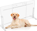Clear acrylic freestanding dog gate with stable feet across a doorway