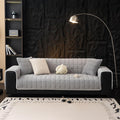 Coffee flannel waterproof pet sofa cover on a three-seat couch