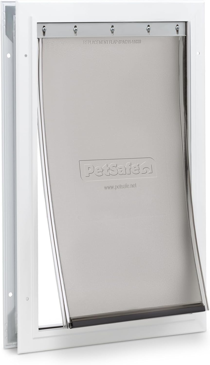 White aluminum-frame pet door with flap installed in an entry door