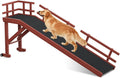 Wooden dog ramp with top platform, side rails and wheels leaning against a bed