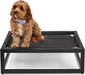 Dark brown elevated dog cot with breathable surface on a patio – view 2