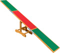 Dog agility seesaw with colored contact zones on a lawn