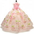 Small dog wearing a pink embroidered tulle ball gown with satin bow