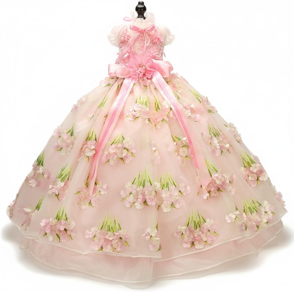 Small dog wearing a pink embroidered tulle ball gown with satin bow