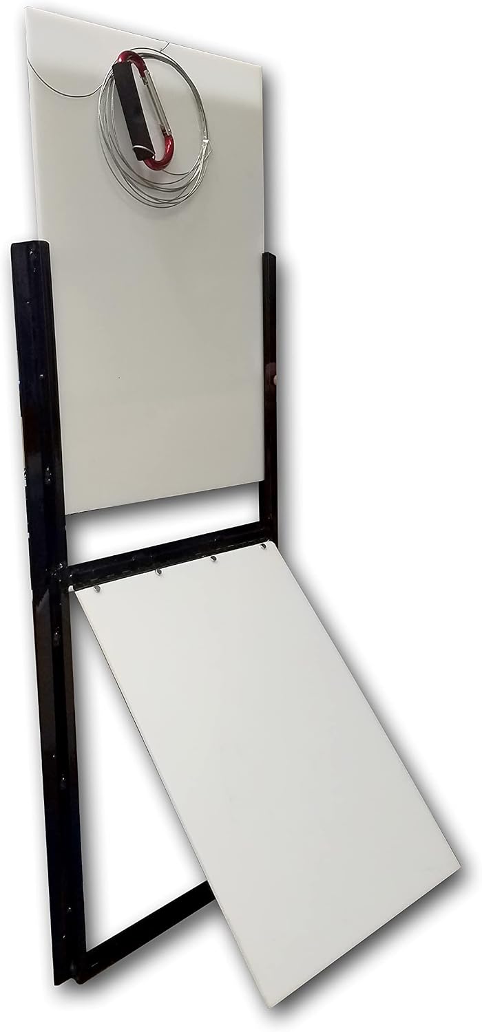 Vertical sliding guillotine dog door with flap installed in a kennel wall
