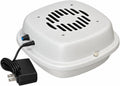 Compact air purifier placed beside a cat litter box