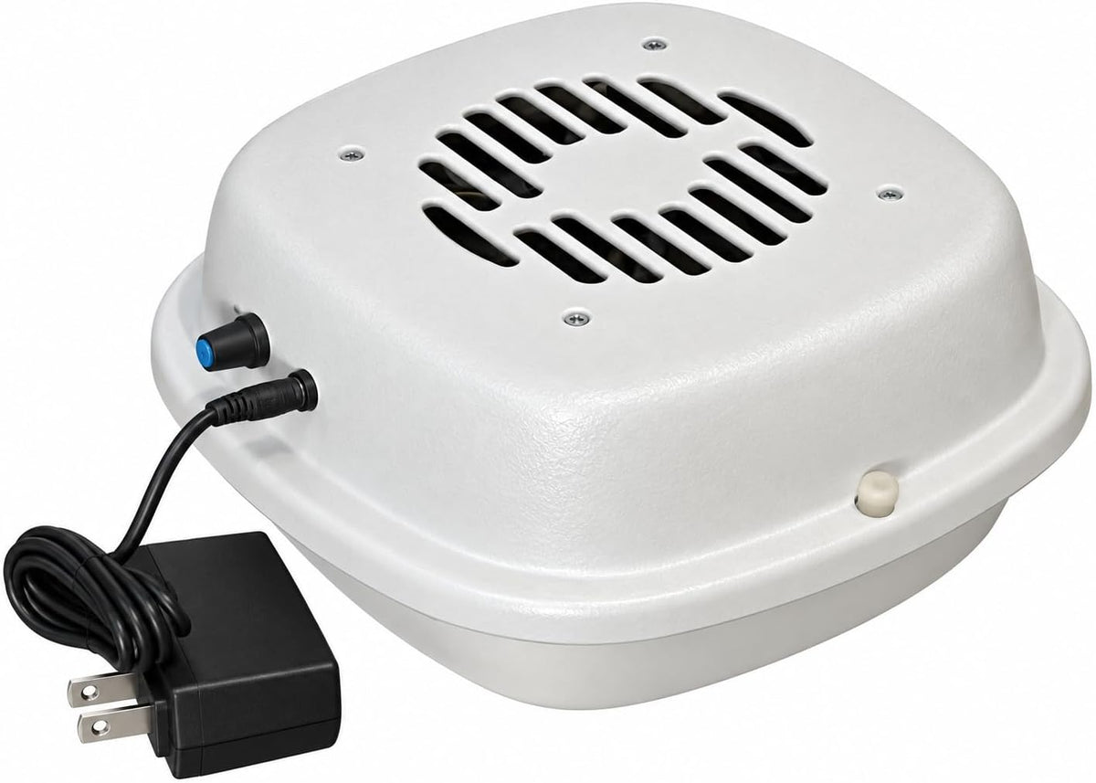 Compact air purifier placed beside a cat litter box