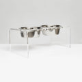Clear acrylic elevated stand holding two silver stainless steel dog bowls