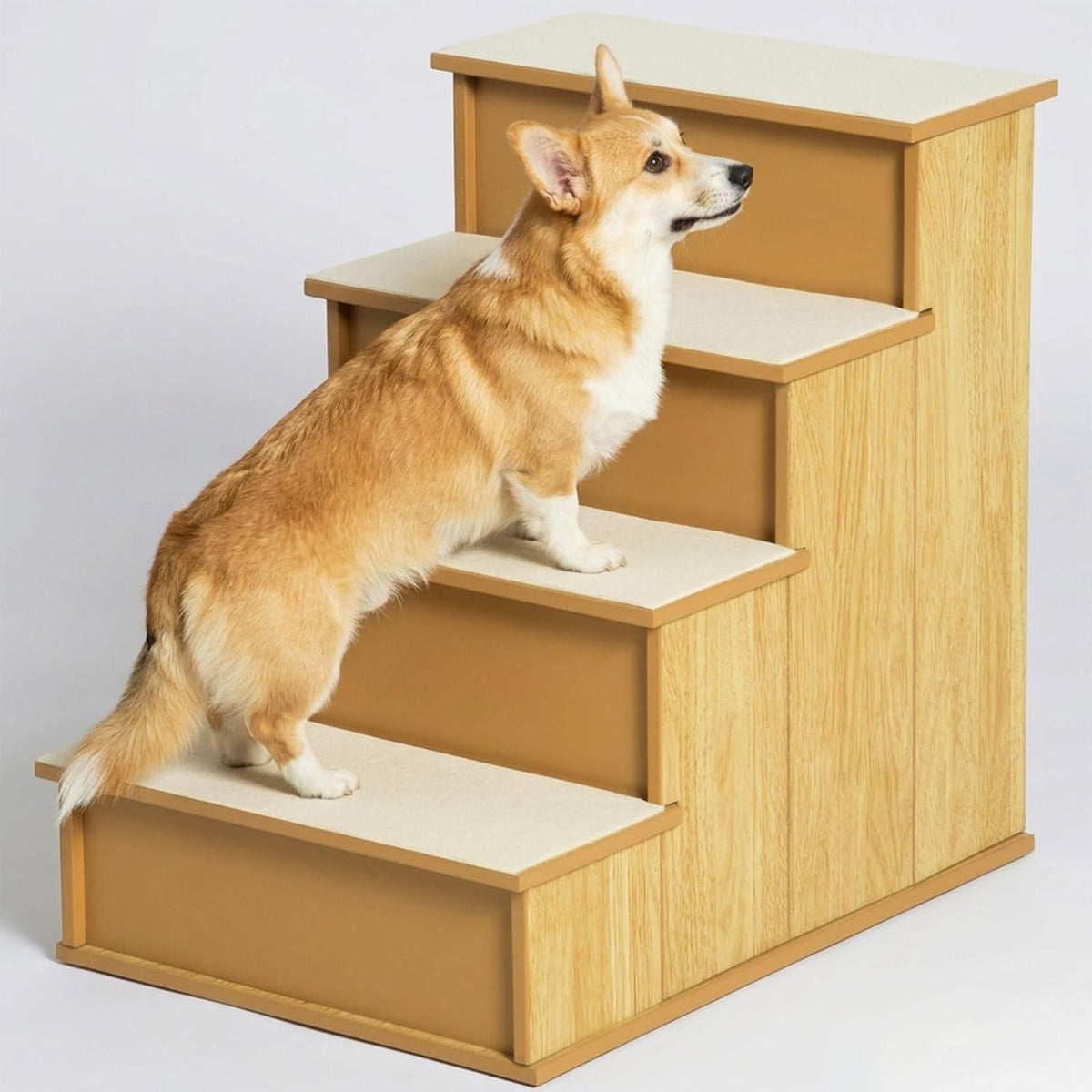 Four-step wooden pet stairs with soft cushioned step covers beside a bed