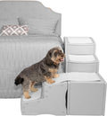 Gray inclined pet stairs placed beside a bed