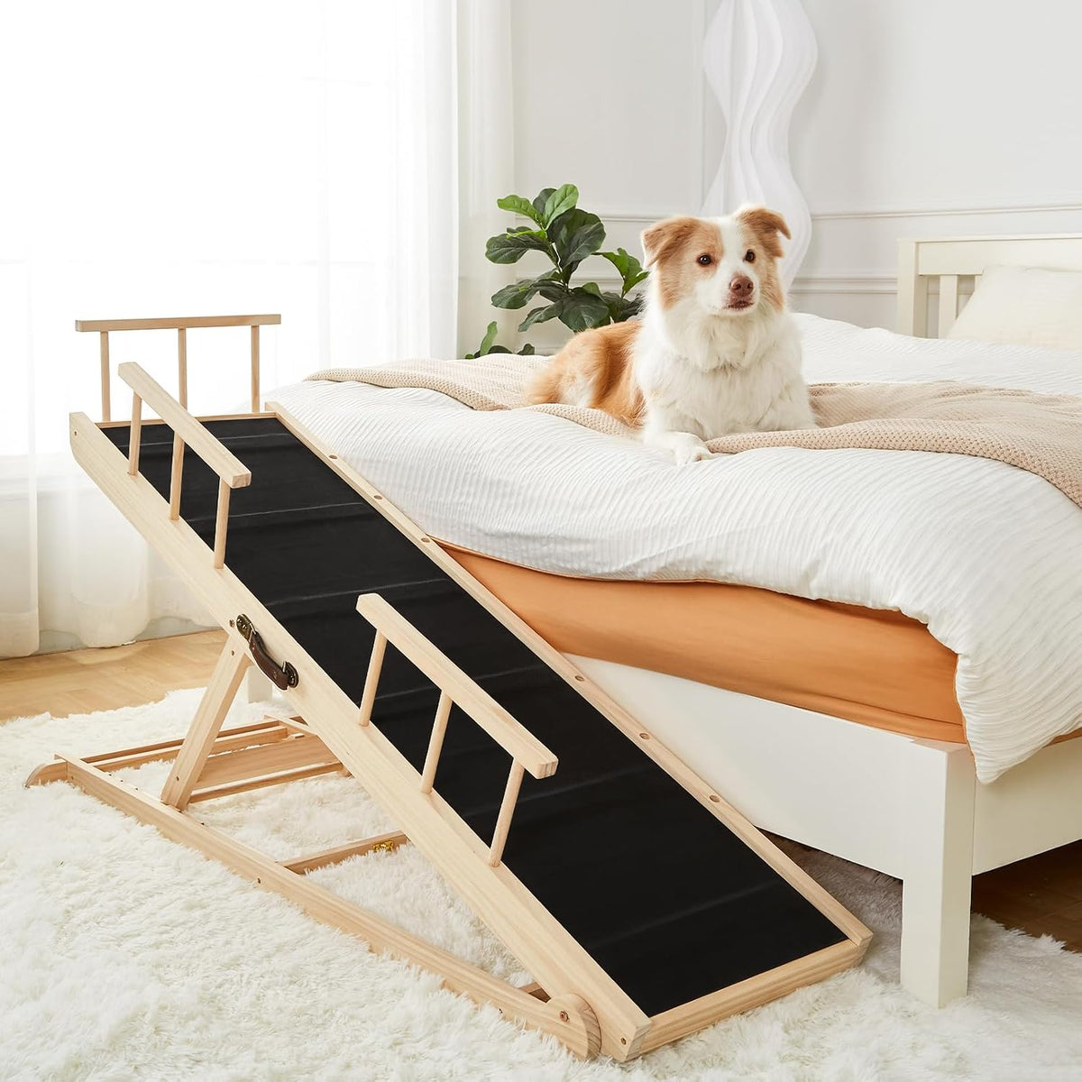 Wooden adjustable dog ramp with side rails leading up to a bed