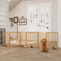 Six-panel foldable bamboo dog gate with metal support stands in a doorway
