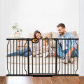 Black extra wide pressure mounted walk-through pet gate in a doorway – view 2