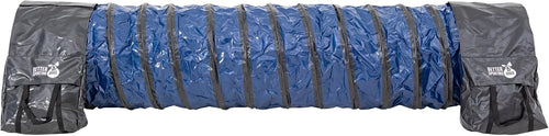 Curved PVC dog agility tunnel held down with sandbags on grass