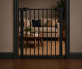 Black 36 inch pressure-mounted pet gate with walk-through door in a hallway – view 2