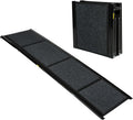 Black foldable felt dog ramp with metal frame leaning against an SUV