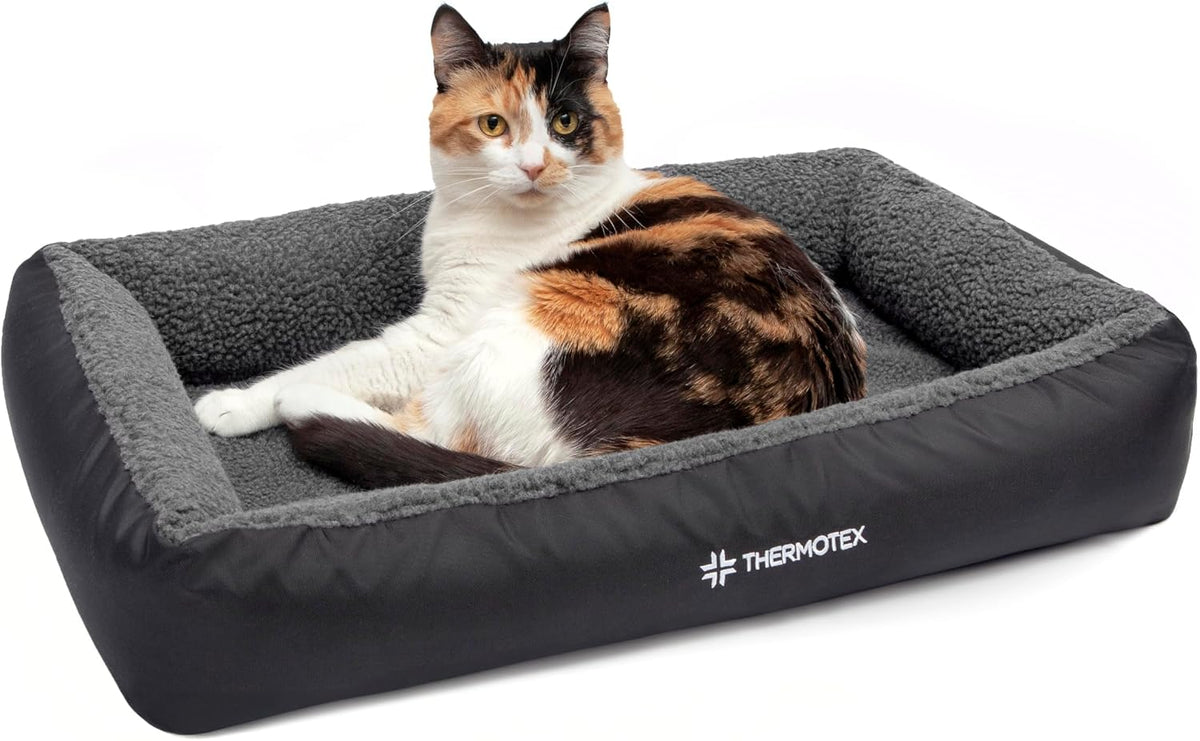 Heated pet bed pad with soft cover sized 23 by 16 inches with a cat resting on it