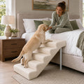 Five step linen dog stairs placed beside a high bed