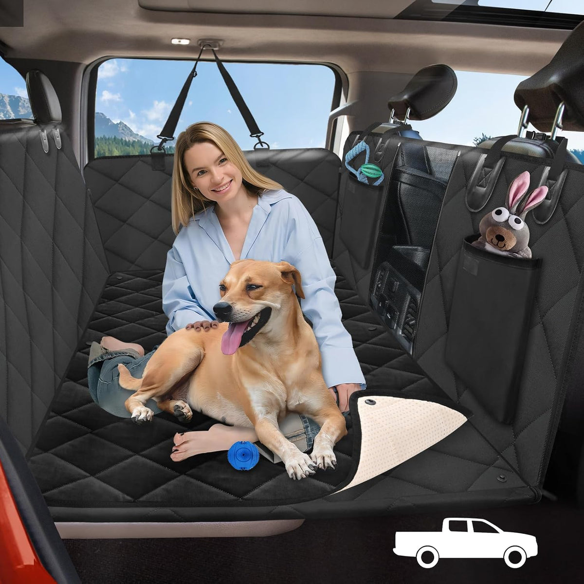 Black hard bottom dog truck seat cover extender with blanket in a crew cab rear seat