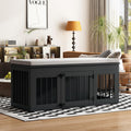 Black wooden dog crate furniture with metal bars and soft gray cushion inside