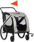 Grey 2-in-1 dog bike trailer with flag attached to a bicycle