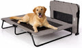 Sand colored elevated pet cot with mesh surface on a patio