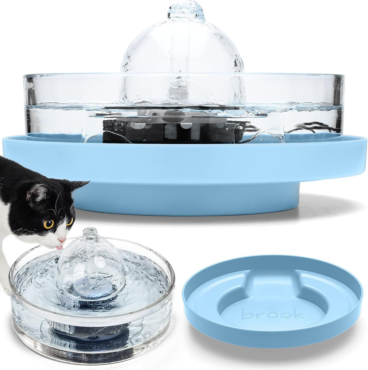 Glass cat water fountain sitting on a blue raised stand