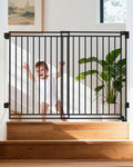 Black no bottom bar pet gate with walk-through door mounted at top of stairs