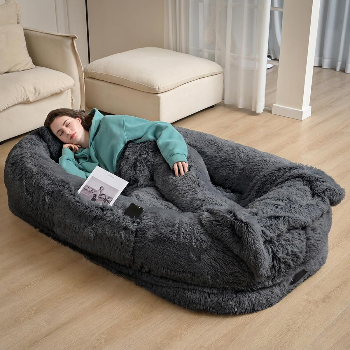 Dark grey human-size faux fur nest bed shared by a person and a large dog