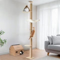 Beige floor to ceiling cat tree with hammock and scratching posts