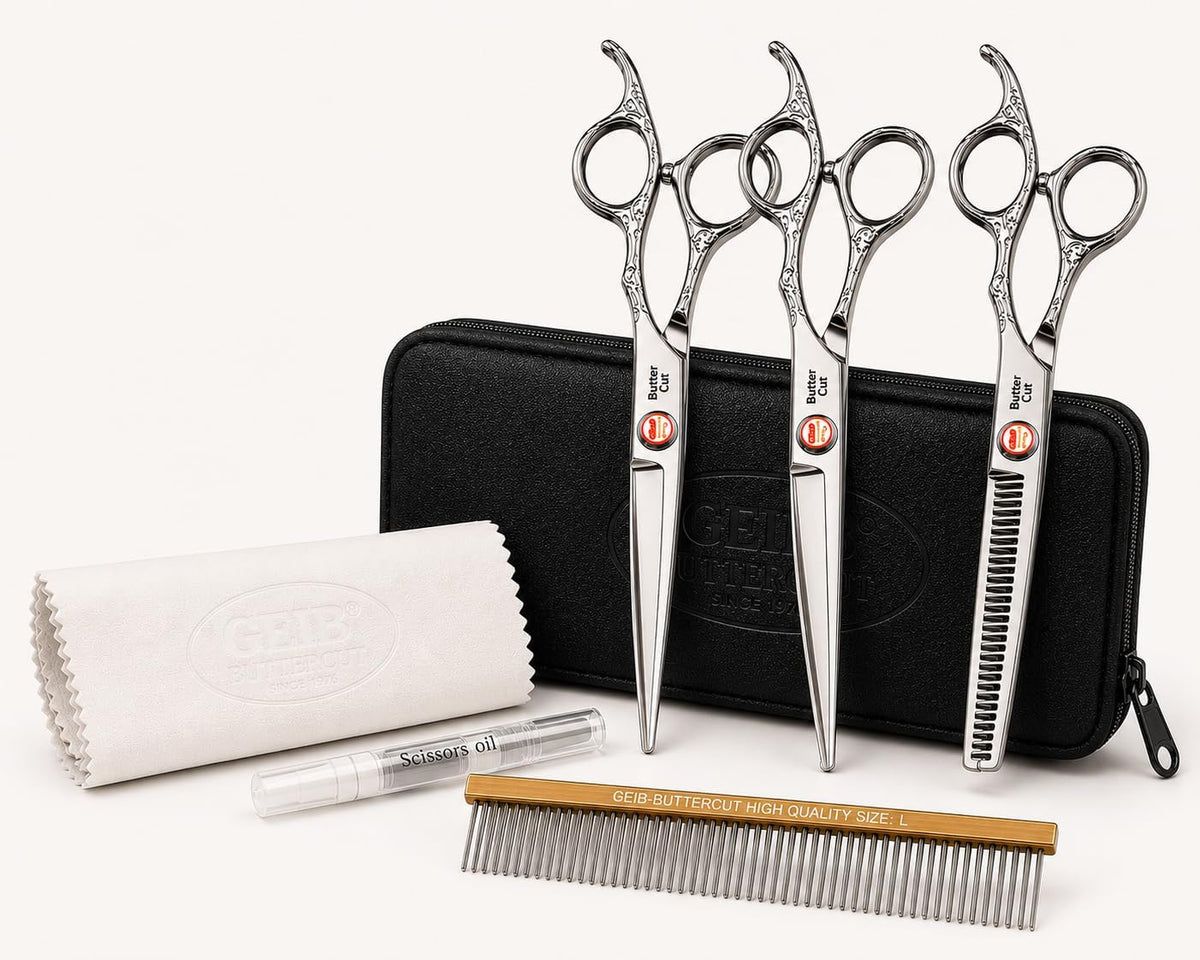 Three stainless steel dog grooming shears laid beside a zipper storage case