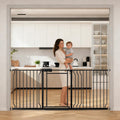 Clear acrylic pressure mounted dog gate with walk-through door in a kitchen doorway