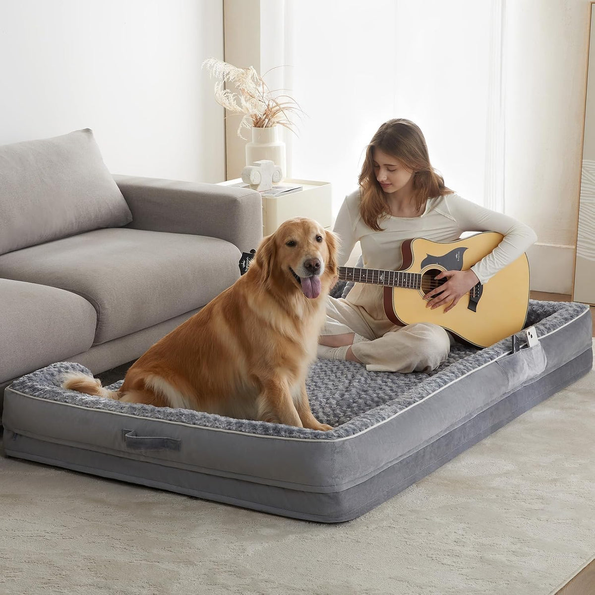 Grey human-size orthopedic dog bed with soft removable cover on a living room floor