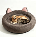 Brown 70 inch round dog bed with ear shapes and a thick bolster rim