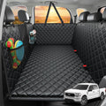 Black hard bottom dog back seat extender in a crew cab truck