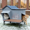Insulated outdoor cat house with heating pad, raised base and two doorways