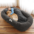 Dark grey human-size faux fur dog bed with blanket and pillow