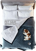 Blue and white waterproof reversible pet blanket on a king bed