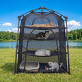 Pop-up mesh cat enclosure tent set up on a patio with a cat inside