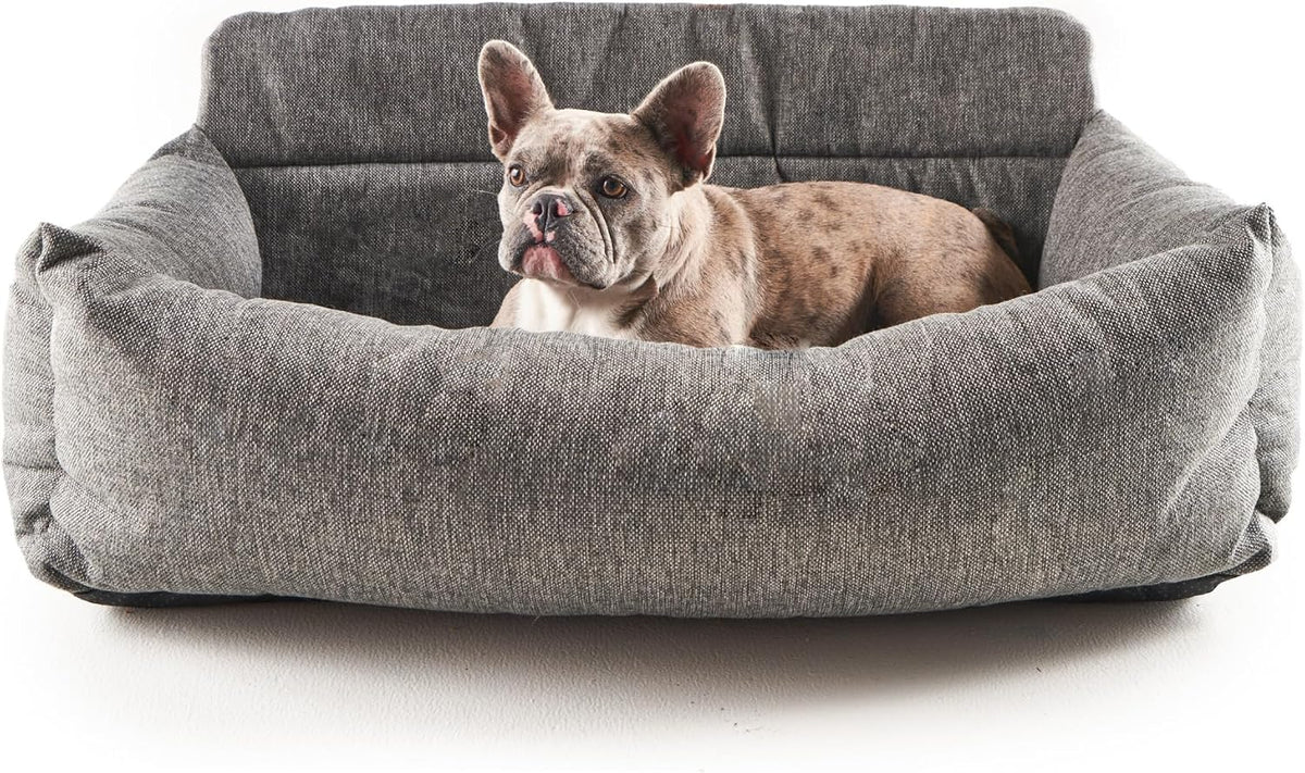 Memory foam dog car bed with bolsters strapped across a back seat