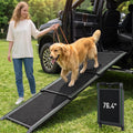 76 inch telescoping dog ramp with textured surface leading onto a bed