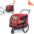 Red collapsible dog bike trailer with mesh doors and safety flag