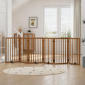 Walnut wooden folding dog gate with metal support feet in a doorway