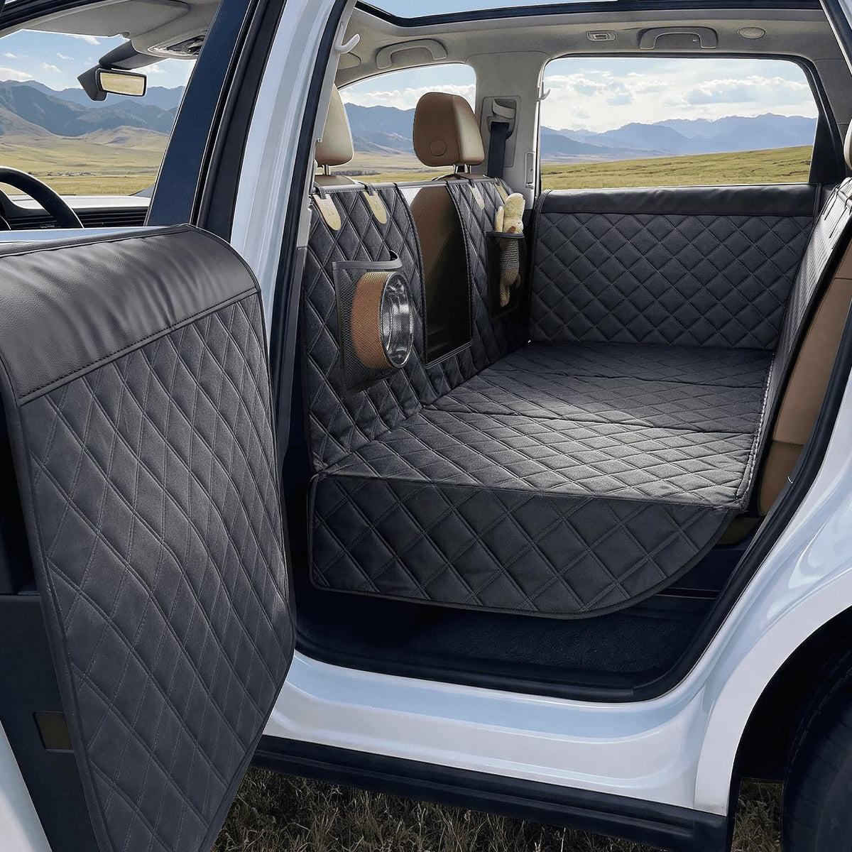 Black hard bottom backseat dog extender with door protectors in an SUV