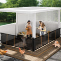 Black retractable mesh pet gate extended across a wide outdoor patio opening