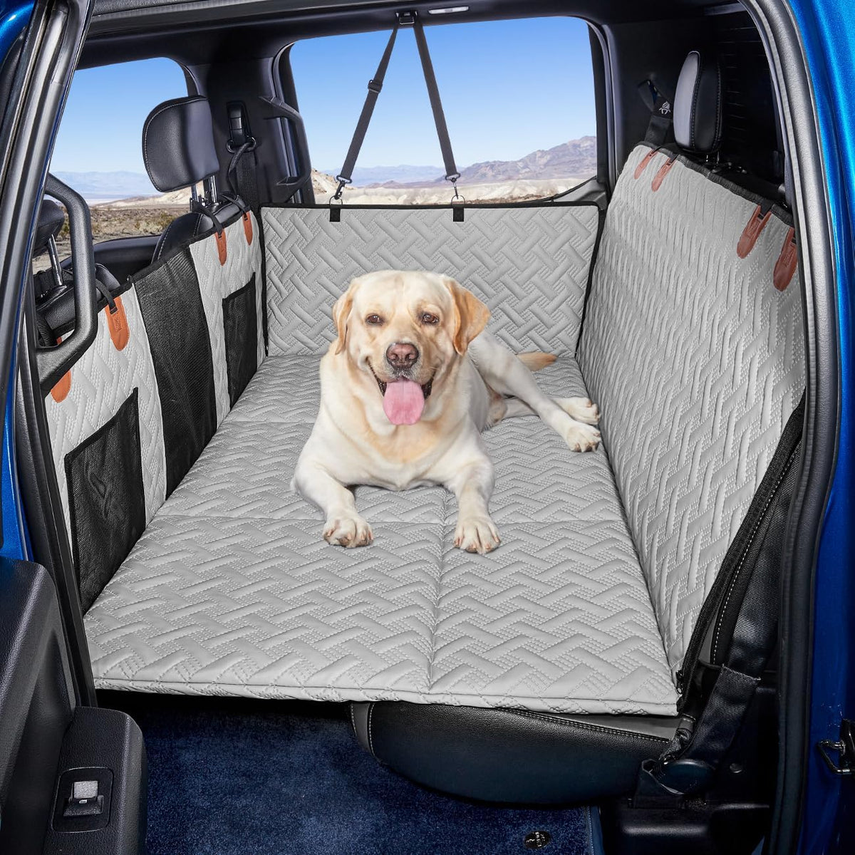 Grey leather hard-bottom dog seat extender in a truck back seat