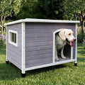 Grey elevated wooden dog house with side window and door flap